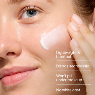 Model applying EltaMD UV Skin Recovery Broad Spectrum SPF 50 mineral sunscreen to her cheek