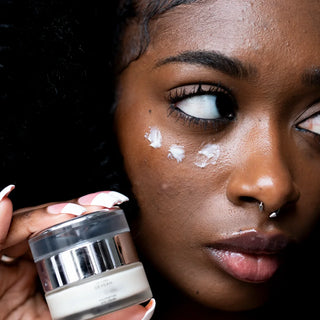 Model with Dr. Lara Devgan Polypeptide Eye Cream jar
