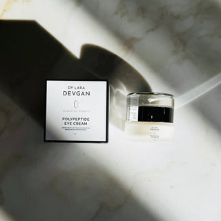 Dr. Lara Devgan Polypeptide Eye Cream jar and box on marble