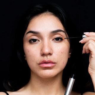 Model applying Dr. Lara Devgan Platinum Long Lash