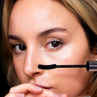 Model applying Dr. Lara Devgan Extreme Lengthening Mascara