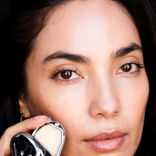 Model holding Dr. Lara Devgan Barrier Balm
