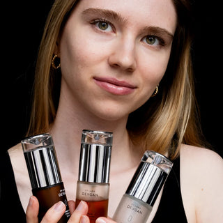 Model holding the three Dr. Lara Devgan Serum Superheroes