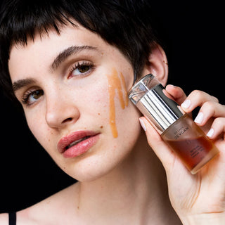 Model holding a Dr. Lara Devgan serum