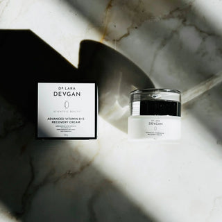 Dr. Lara Devgan Advanced Vitamin B+E Recovery Cream jar and box on marble